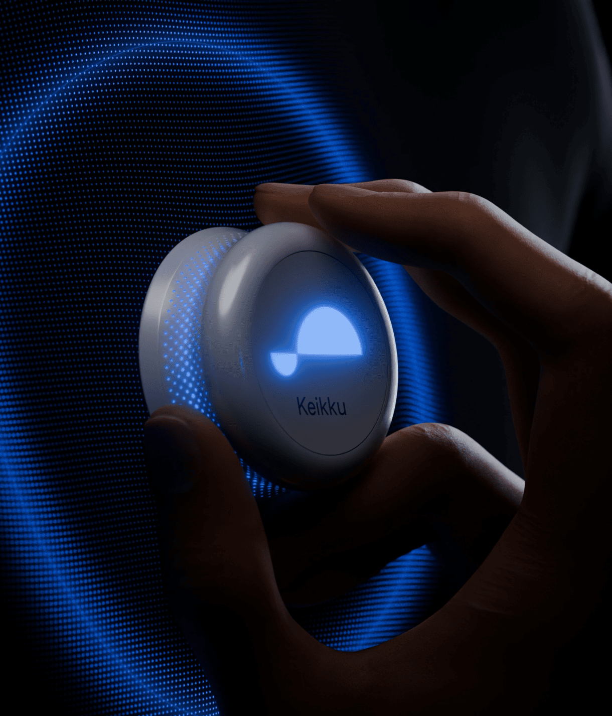 A hand holding a small, round device with a glowing blue light on its surface. The device has the word 'Keikku' written on it. The background features a blue, circular pattern that appears illuminated or digital, suggesting advanced technology or a futuristic design.